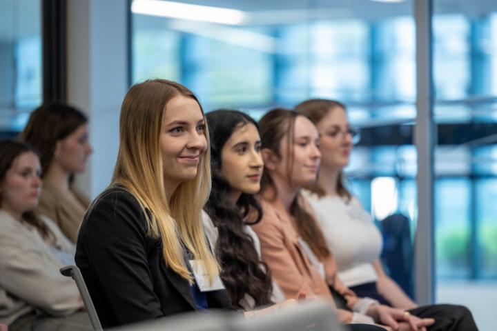 A group of students listen to the panel