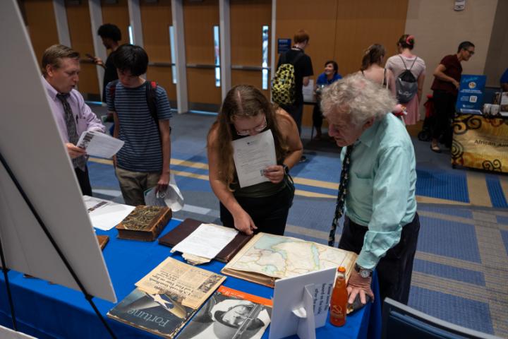 Professor and student looking over a map and chatting